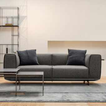 Sophisticated Horm Coleman sofa with dark gray textile upholstery and distinctive aluminum frame built with solid canaletto walnut feet