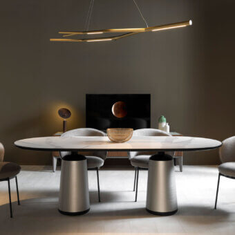 Distinguished Horm Marien table with light gray and white marble tabletop edged in black and brushed silver metal base