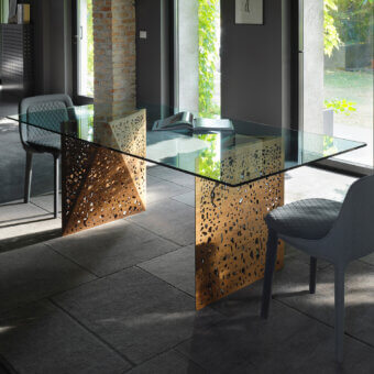 Avant-garde Horm Riddled table crafted in Italy with a glass top and warm wood legs inspired by architectural porosity