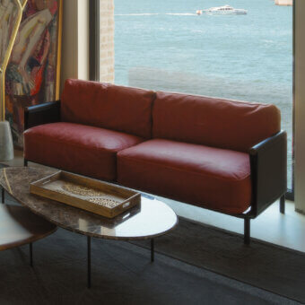 Elegant Horm SC2 sofa with a black painted tubular cage, reddish-brown leather upholstery and Canaletto walnut details