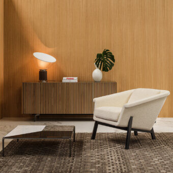 Superior Horm Sienna lounge chair with enveloping comfort upholstered in cream fabric and dark finished wooden legs