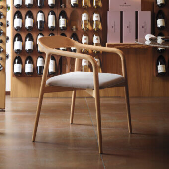 Elegant Horm Velasca armchair crafted in solid ash with a light gray textile seat and smooth matte finish
