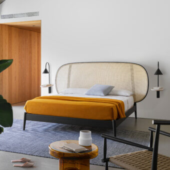 Elegant Miniforms Shiko Wien bed crafted with wood and woven cane, featuring a matte black finish and rounded headboard