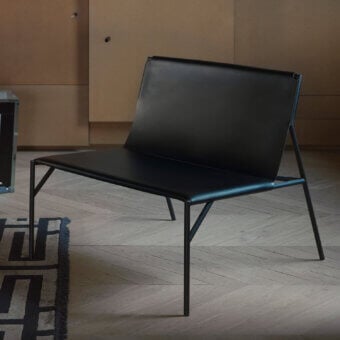 Distinguished Horm Tout Le Jour lounge chair crafted in black leather with a sleek angular metal silhouette