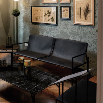 Exclusive Horm Tout Le Jour sofa crafted in Italy with black leather upholstery and a matte metal frame