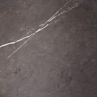 Neolith sintered stone slab, dark gray with white veins, matte finish, organic pattern, close-up texture detail.