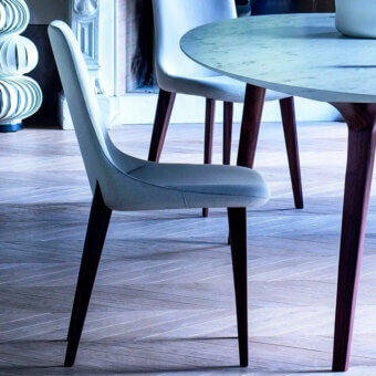 Superior Bross Ascot chair with light gray fabric upholstery and dark brown stained oakwood legs