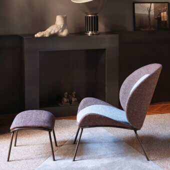 Distinguished Bross Baltea lounge chair with woven fabric upholstery in muted brown and blue, built with a sleek metal structure and footstool