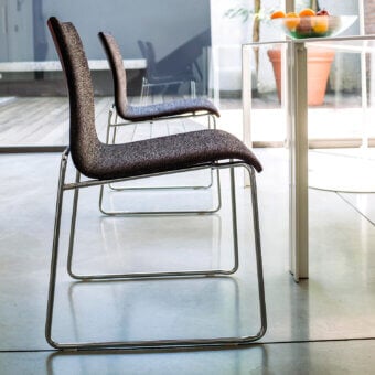 Distinguished Bross Bee chair with a metal frame and premium fabric upholstery in dark grey and brown tones with a polished finish