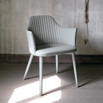 Superior Bross Break armchair crafted in Italy with premium fabric upholstery and lacquered wood legs