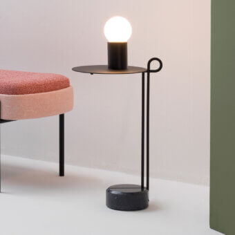 Distinguished Bross Loop coffee table with looping matte black steel and Black Marquina marble base for a contemporary aesthetic