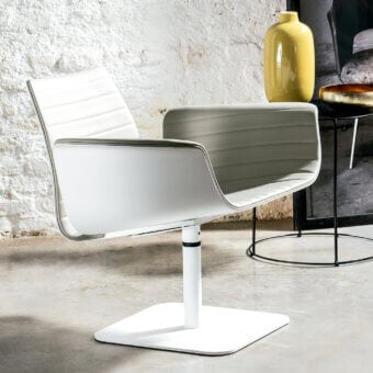 Distinguished Bross Meeting lounge chair fully upholstered in premium white fabric with quilted detailing and sleek metal base