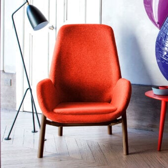 Distinguished Bross Mysa lounge chair with vibrant orange textured fabric upholstery and visible cylindrical wooden legs