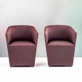 Captivating Bross Nest Lounge chair with reddish-brown fabric upholstery and skilled wood accents