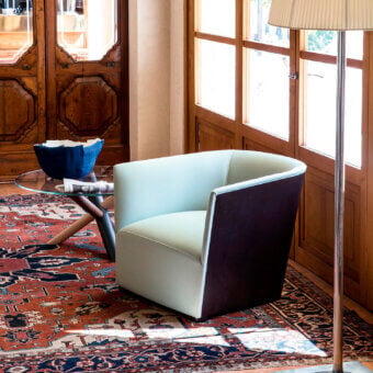 Distinguished Bross Nest lounge chair with mint-green seat and dark brown textile exterior, crafted in Italy with a matte finish