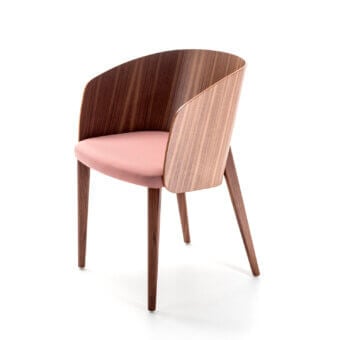 Superior Bross Shell armchair with curved plywood, soft pink fabric seat and richly grained darker wood legs