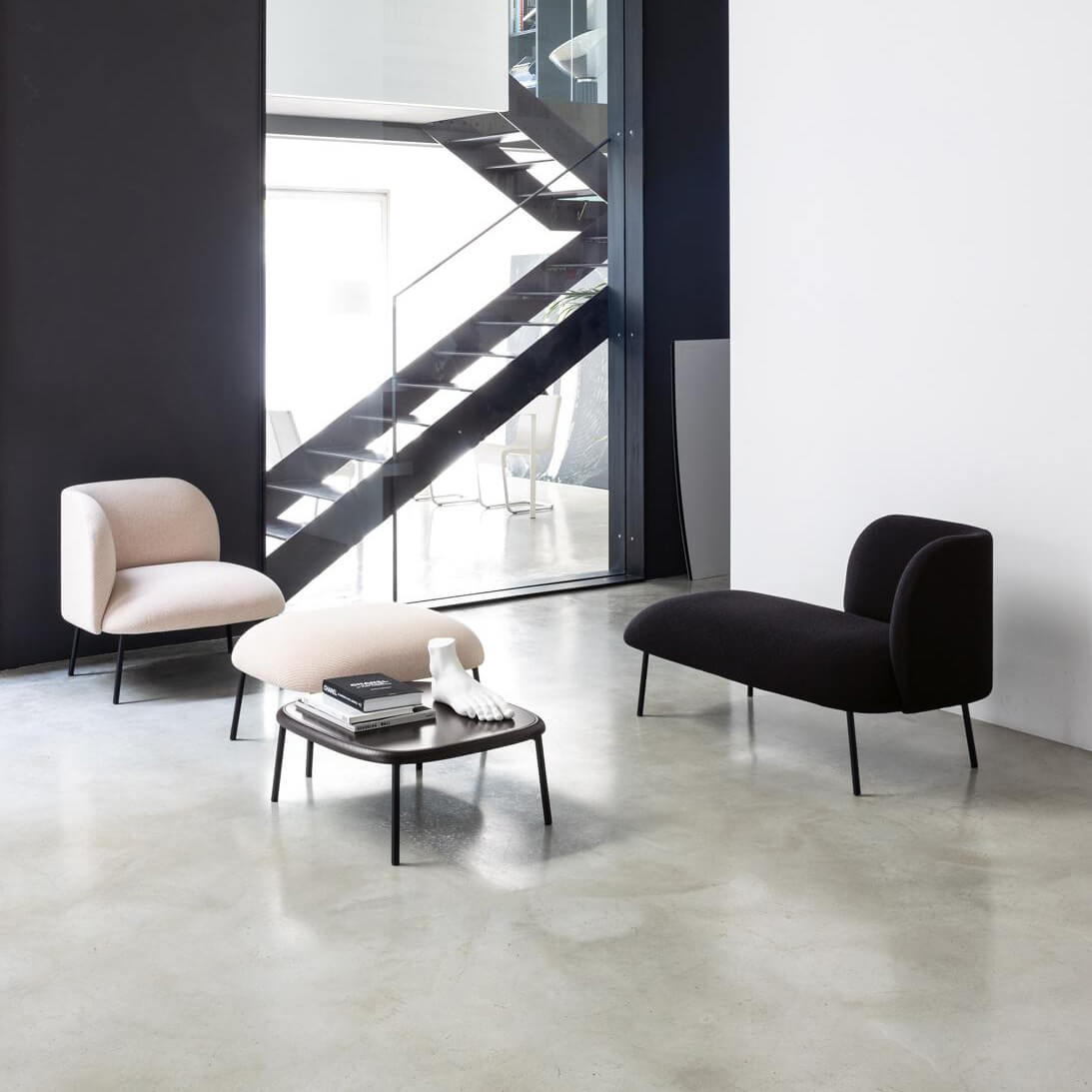 Distinguished Bross Sit chaise lounge crafted with black textile upholstery and a sleek metal frame in Italy