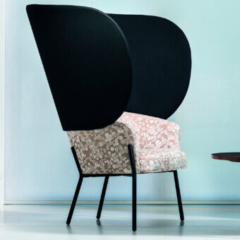 Distinguished Bross Wam lounge chair crafted in patterned textile with light pink, beige, and white shapes with matte black metal legs