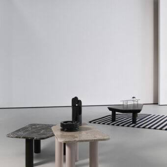 Captivating Cierre1972 Iceberg coffee table with a black matte wood top and cylindrical legs supporting a glass sphere