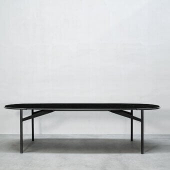 Elegant Cierre1972 Mac table crafted in Italy with oval matte stone-like tabletop and sleek dark metal frame