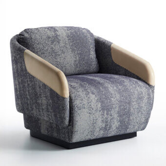 Sophisticated Casamania Worn lounge chair upholstered in textured gray and blue fabric with light tan faux leather accents