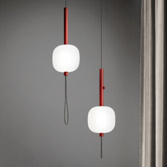 Elegant Kundalini Motus suspension lamp with rounded opal glass diffuser and striking red cylindrical metal support
