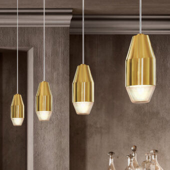 Captivating Kundalini Yuma suspension lamp with spun metal reflector and blown glass diffuser in polished brass finish
