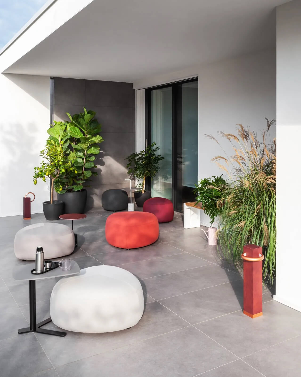 Captivating Lapalma Kipu outdoor ottoman with rounded triangular shape upholstered in vibrant red UV-stable fabric