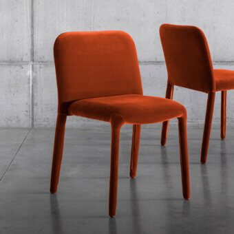 Distinguished Miniforms Pelè chair completely padded with uniform orange-red textile showcasing a matte finish