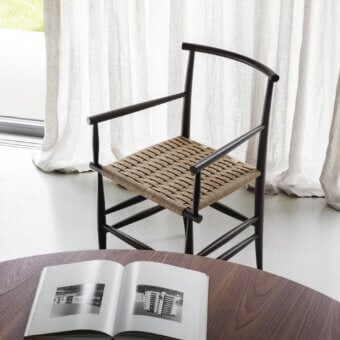 Elegant Miniforms Pelleossa chair with dark wood frame and light brown woven seat exhibiting a matte finish