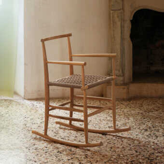 Distinguished Miniforms Pelleossa rocking chair with woven brown textile seat and curved light brown solid wood base