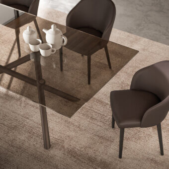 Exceptional Ozzio Italia Random table with transparent glass top and sculptural dark-toned metal tube base crafted with visible welds