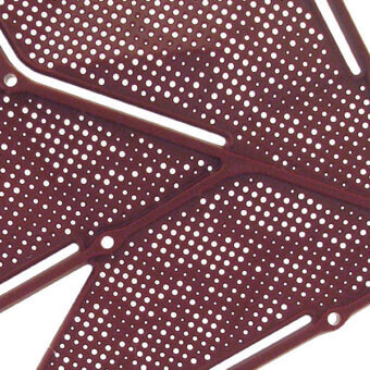 Burgundy metal grille with circular perforations and asymmetrical white leaf design, featuring mounting holes and a matte finish.