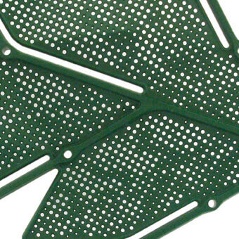 Dark green metal grille with circular perforations and white linear elements forming an abstract foliage pattern against a white backdrop.