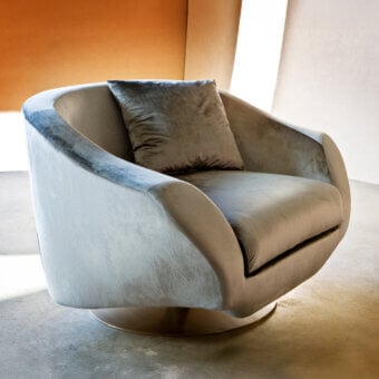 Lavish Casa Casati Grande lounge chair upholstered in muted gray textile with tonal variations and gold chrome revolving base