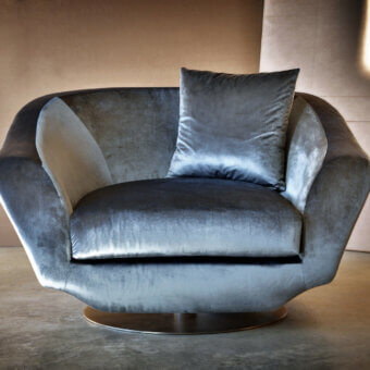 Superior Casa Casati Grande lounge chair upholstered in lustrous gray textile with gold chrome revolving base and beech wood frame