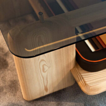 Elegant Casa Casati Toro coffee table with smoked tempered glass and light ash wood, plus a black and orange leather tray