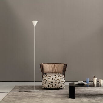 Elegant Cierre1972 Riviera coffee table with woven frame and patterned textile cushion in brown, black, and white tones