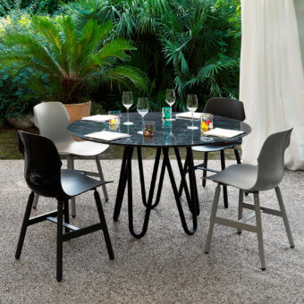 Distinctive Casamania Stereo chair with glossy dark synthetic seat and matte black metal legs