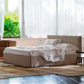 Elegant Horm Tahiti bed with beige textile upholstery and mocha lacquered solid beechwood feet