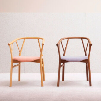 Superior Miniforms Valerie armchair with light pink textile seat and light-toned wood frame built with curved armrests