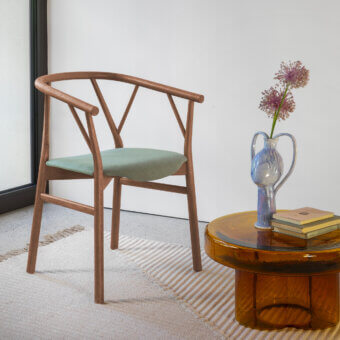 Distinguished Miniforms Valerie armchair with muted green cushioned seat and smooth medium-toned wooden frame