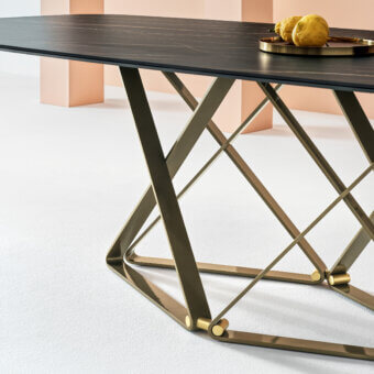 Exclusive Bontempi Delta Barrel table crafted in dark tones with a reflective bronze geometric base