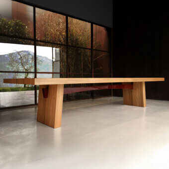 Wa table light wood angled supports red geometric insets modern interior concrete floor bamboo landscape Casa Casati design.