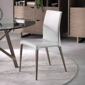 Distinguished Pacini & Cappellini Eva chair with solid ash wood structure and smooth white upholstery exhibiting a matte finish