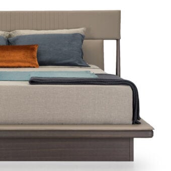 Turri Vine bed, dark brown wood and beige upholstery, rectangular platform with channel headboard and layered pillows.