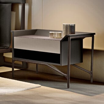 Exceptional Turri Vine nightstand with asymmetrical form in leather and wood, showcasing a two-tone drawer and angled supports