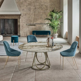 Exceptional Bontempi Louis round table with a light beige faux-marble top and stark metal ovals built with a sleek glass surface