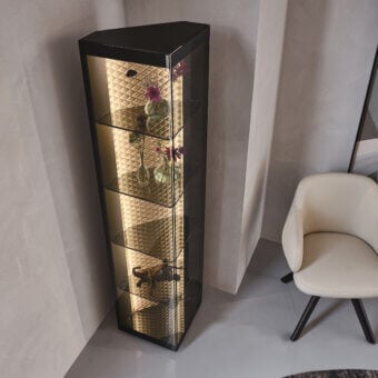 Elegant Cattelan Italia Atelier showcase with triangular form, smoked glass shelves and diamond-quilted leather backdrop illuminated by integrated lighting