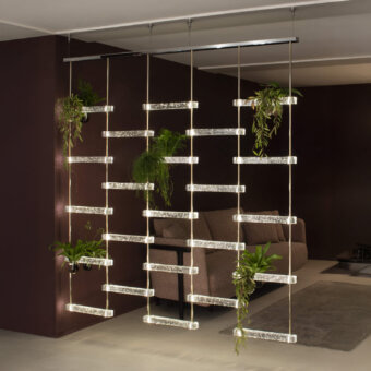 Distinguished Italamp Piola suspension lamp with refined cast glass bars and light gold metal structure creating a sparkling architectural glow